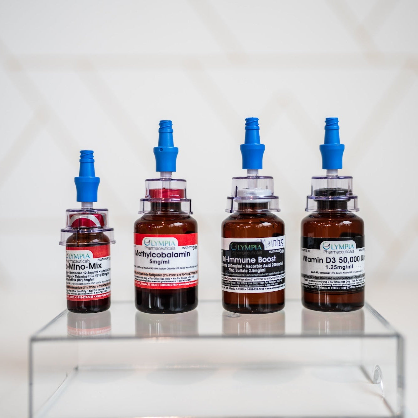 Bottles of Olympa vitamin injection supplements available at Bloom Aesthetics in Spokane to boost energy, immunity, and glow